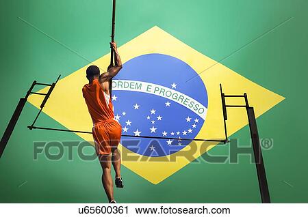 Full length rear view of male athlete jumping over bar against Brazilian flag View Large Photo Image Stock Image - Full length rear view of male athlete jumping over bar against Brazilian flag. Fotosearch