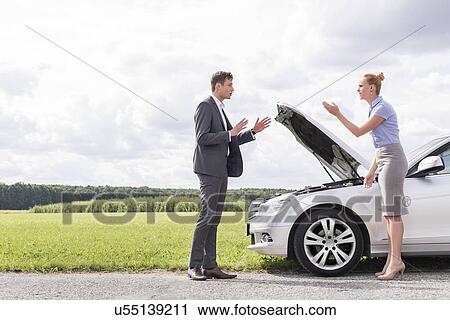 Full length side view of business couple arguing over broken car at countryside View Large Photo Image Stock Image - Full length side view of business couple arguing over broken car at countryside. Fotosearch