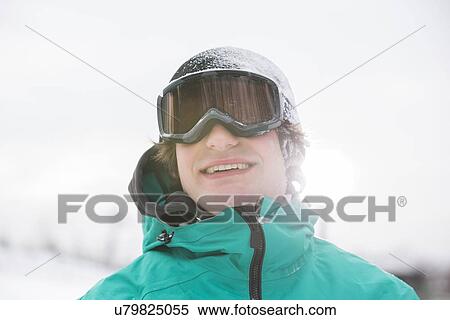 Stock Photography - Handsome young man wearing ski goggles outdoors. Fotosearch