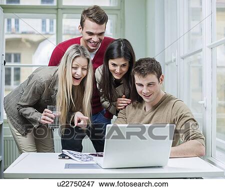 Happy business people using laptop in meeting View Large Photo Image Stock Photo - Happy business people using laptop in meeting. Fotosearch