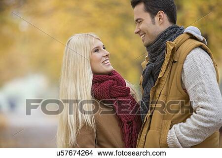 Picture - Happy couple looking at each other in park. Fotosearch