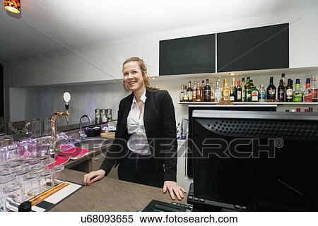 Happy female cashier at counter in restaurant View Large Photo Image Stock Photography - Happy female cashier at counter in restaurant. Fotosearch
