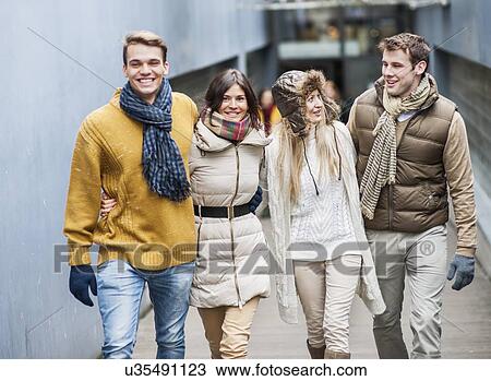 Happy friends walking together in lane View Large Photo Image Stock Image - Happy friends walking together in lane. Fotosearch