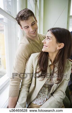 Happy romantic couple looking at each other at home View Large Photo Image Stock Photo - Happy romantic couple looking at each other at home. Fotosearch