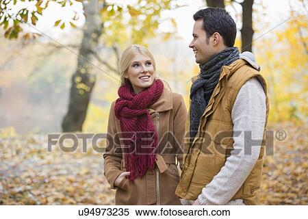 Happy woman looking at man during autumn View Large Photo Image Stock Photography - Happy woman looking at man during autumn. Fotosearch