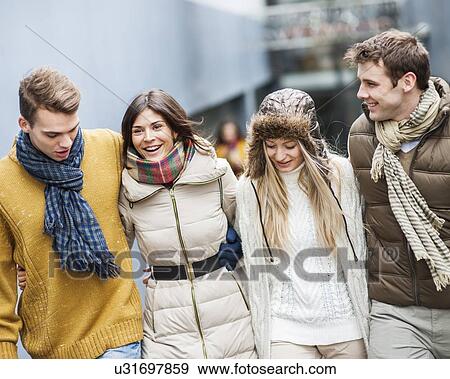 Happy young friends walking together outdoors View Large Photo Image Stock Photo - Happy young friends walking together outdoors. Fotosearch