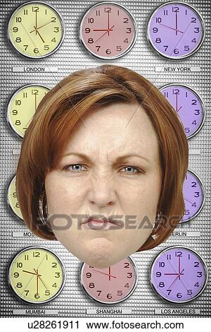 Stock Image - Headshot of angry businesswoman with different time zone clocks in background. Fotosearch