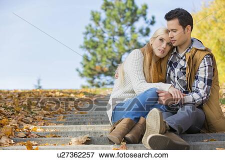 Stock Photo - Loving couple sitting on park steps. Fotosearch