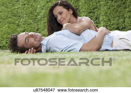Stock Photo - Loving young couple spending quality time in park. Fotosearch