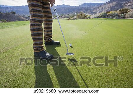 Low section of senior male golfer playing at golf course View Large Photo Image Stock Image - Low section of senior male golfer playing at golf course. Fotosearch