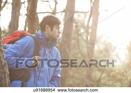Make hiker carrying backpack in forest View Large Photo Image Picture - Make hiker carrying backpack in forest. Fotosearch