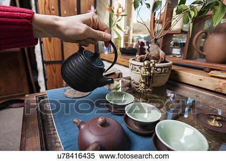 Male hand pouring tea into tea cups in store View Large Photo Image Stock Photography - Male hand pouring tea into tea cups in store. Fotosearch