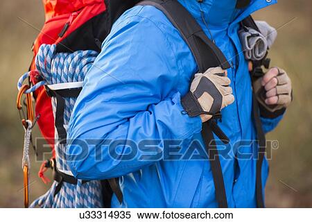 Midsection of male hiker carrying backpack outdoors View Large Photo Image Stock Photography - Midsection of male hiker carrying backpack outdoors. Fotosearch