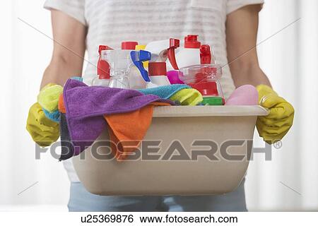 Midsection of woman carrying basket of cleaning supplies View Large Photo Image Stock Photograph - Midsection of woman carrying basket of cleaning supplies. Fotosearch