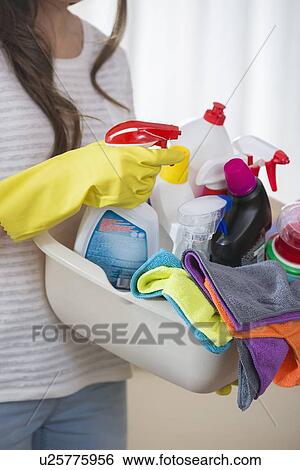 Midsection of woman carrying basket of cleaning supplies at home View Large Photo Image Stock Photograph - Midsection of woman carrying basket of cleaning supplies at home. Fotosearch
