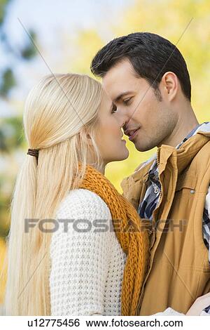 Stock Photograph - Passionate couple kissing in park. Fotosearch