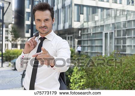 Portrait of angry businessman pointing at you outside office building View Large Photo Image Stock Photo - Portrait of angry businessman pointing at you outside office building. Fotosearch
