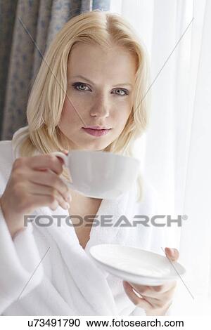 Portrait of attractive young woman in bathrobe drinking coffee at hotel room View Large Photo Image Stock Image - Portrait of attractive young woman in bathrobe drinking coffee at hotel room. Fotosearch