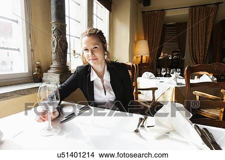 Portrait of beautiful customer with wine glass at restaurant table View Large Photo Image Picture - Portrait of beautiful customer with wine glass at restaurant table. Fotosearch