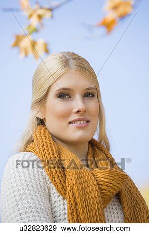 Stock Photo - Portrait of beautiful woman smiling against sky. Fotosearch