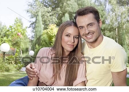Picture - Portrait of beautiful young couple spending leisure time in park. Fotosearch