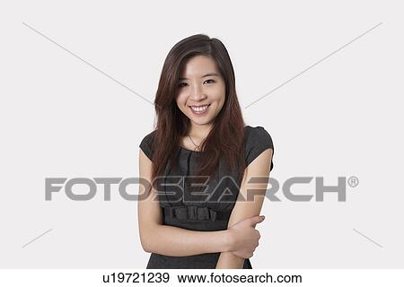 Portrait of beautiful young businesswoman smiling over white background View Large Photo Image Stock Photo - Portrait of beautiful young businesswoman smiling over white background. Fotosearch