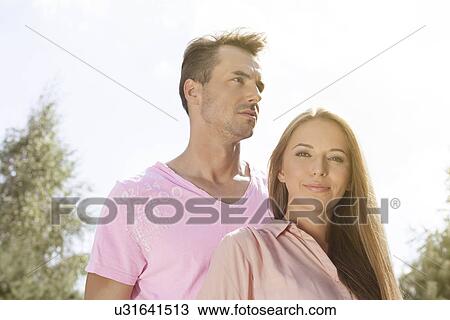 Portrait of beautiful young woman with man in park View Large Photo Image Stock Image - Portrait of beautiful young woman with man in park. Fotosearch