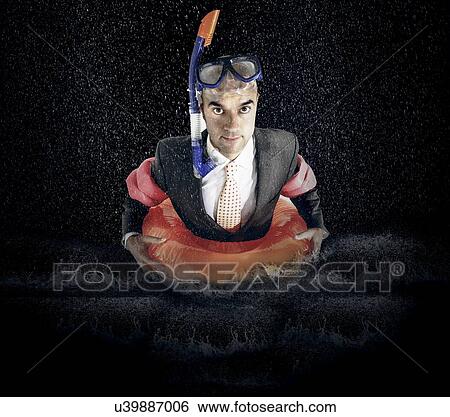 Stock Photograph - Portrait of businessman with diving equipment in water. Fotosearch