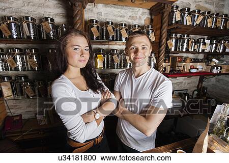 Portrait of confident couple standing arms crossed in tea store View Large Photo Image Stock Image - Portrait of confident couple standing arms crossed in tea store. Fotosearch