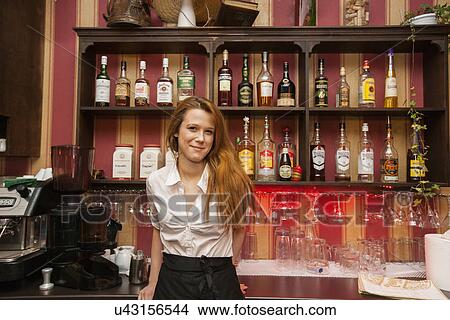 Portrait of confident female bartender at counter View Large Photo Image Picture - Portrait of confident female bartender at counter. Fotosearch