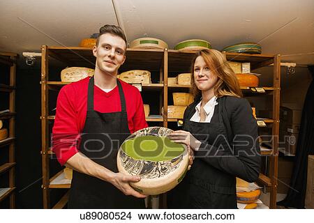 Portrait of confident salespeople showing cheese in shop View Large Photo Image Picture - Portrait of confident salespeople showing cheese in shop. Fotosearch