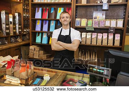 Portrait of confident salesperson in coffee store View Large Photo Image Stock Image - Portrait of confident salesperson in coffee store. Fotosearch