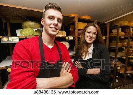 Portrait of confident store clerks in cheese shop View Large Photo Image Stock Photography - Portrait of confident store clerks in cheese shop. Fotosearch