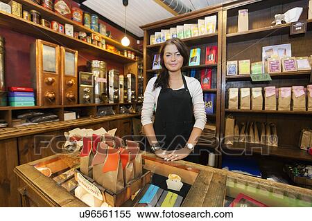 Stock Photography - Portrait of female salesperson working in coffee shop. Fotosearch