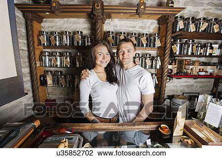 Portrait of happy couple standing together in tea store View Large Photo Image Stock Image - Portrait of happy couple standing together in tea store. Fotosearch