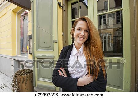 Portrait of happy female owner standing arms crossed outside restaurant View Large Photo Image Stock Photograph - Portrait of happy female owner standing arms crossed outside restaurant. Fotosearch