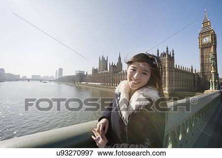 Portrait of happy female tourist visiting Big Ben at London, England, UK View Large Photo Image Stock Photo - Portrait of happy female tourist visiting Big Ben at London, England, UK. Fotosearch