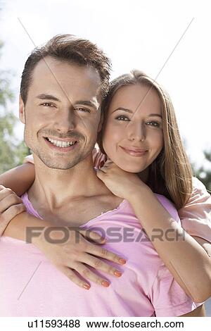 Portrait of happy young couple spending quality time outdoors View Large Photo Image Stock Photo - Portrait of happy young couple spending quality time outdoors. Fotosearch