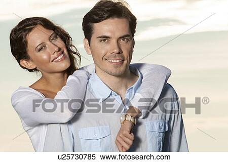 Portrait of loving couple smiling together at beach View Large Photo Image Stock Photography - Portrait of loving couple smiling together at beach. Fotosearch