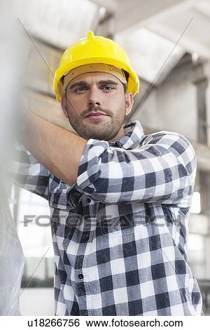 Stock Photograph - Portrait of manual worker working in industry. Fotosearch