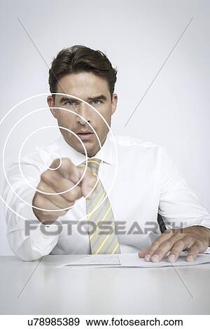Portrait of serious businessman touching visual screen over white background View Large Photo Image Stock Photo - Portrait of serious businessman touching visual screen over white background. Fotosearch