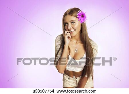 Portrait of shy young woman smiling against pink background View Large Photo Image Picture - Portrait of shy young woman smiling against pink background. Fotosearch