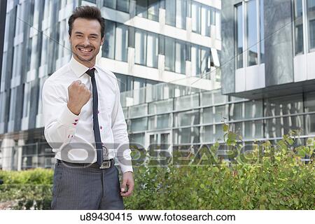 Portrait of successful businessman standing outside office building View Large Photo Image Stock Photography - Portrait of successful businessman standing outside office building. Fotosearch