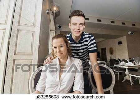 Stock Photo - Portrait of young couple in restaurant. Fotosearch