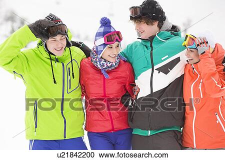 Portrait of young friends in warm clothing outdoors View Large Photo Image Stock Image - Portrait of young friends in warm clothing outdoors. Fotosearch