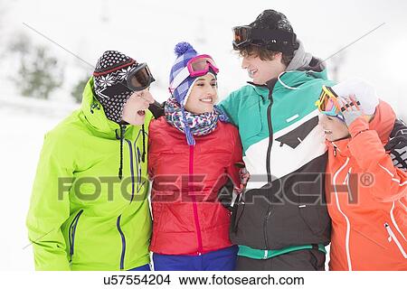 Portrait of young friends standing together in snow View Large Photo Image Picture - Portrait of young friends standing together in snow. Fotosearch