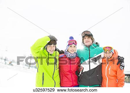 Portrait of young friends standing together in snow View Large Photo Image Stock Photo - Portrait of young friends standing together in snow. Fotosearch