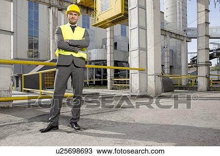 Portrait of young male architect standing arms crossed outside industry View Large Photo Image Stock Image - Portrait of young male architect standing arms crossed outside industry. Fotosearch