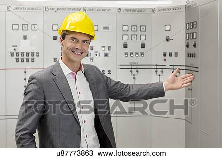 Stock Image - Portrait of young male manager gesturing in control room. Fotosearch
