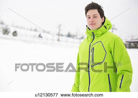 Portrait of young man wearing hooded jacket in snow View Large Photo Image Stock Photo - Portrait of young man wearing hooded jacket in snow. Fotosearch
